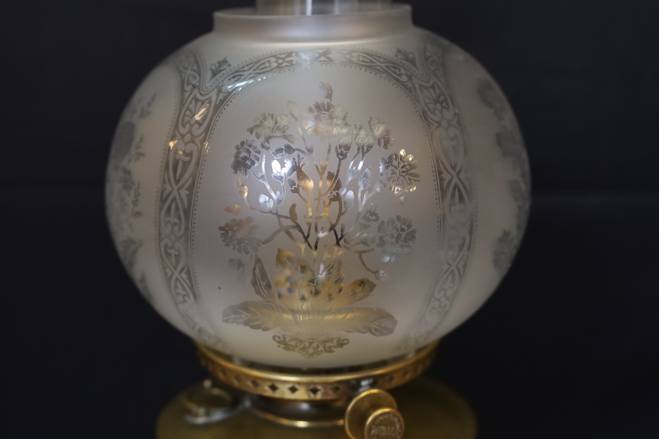 A late 19 century Austrian brass oil lamp with Ditmar mechanism and etched glass shade, converted to electricity, height overall 78cm